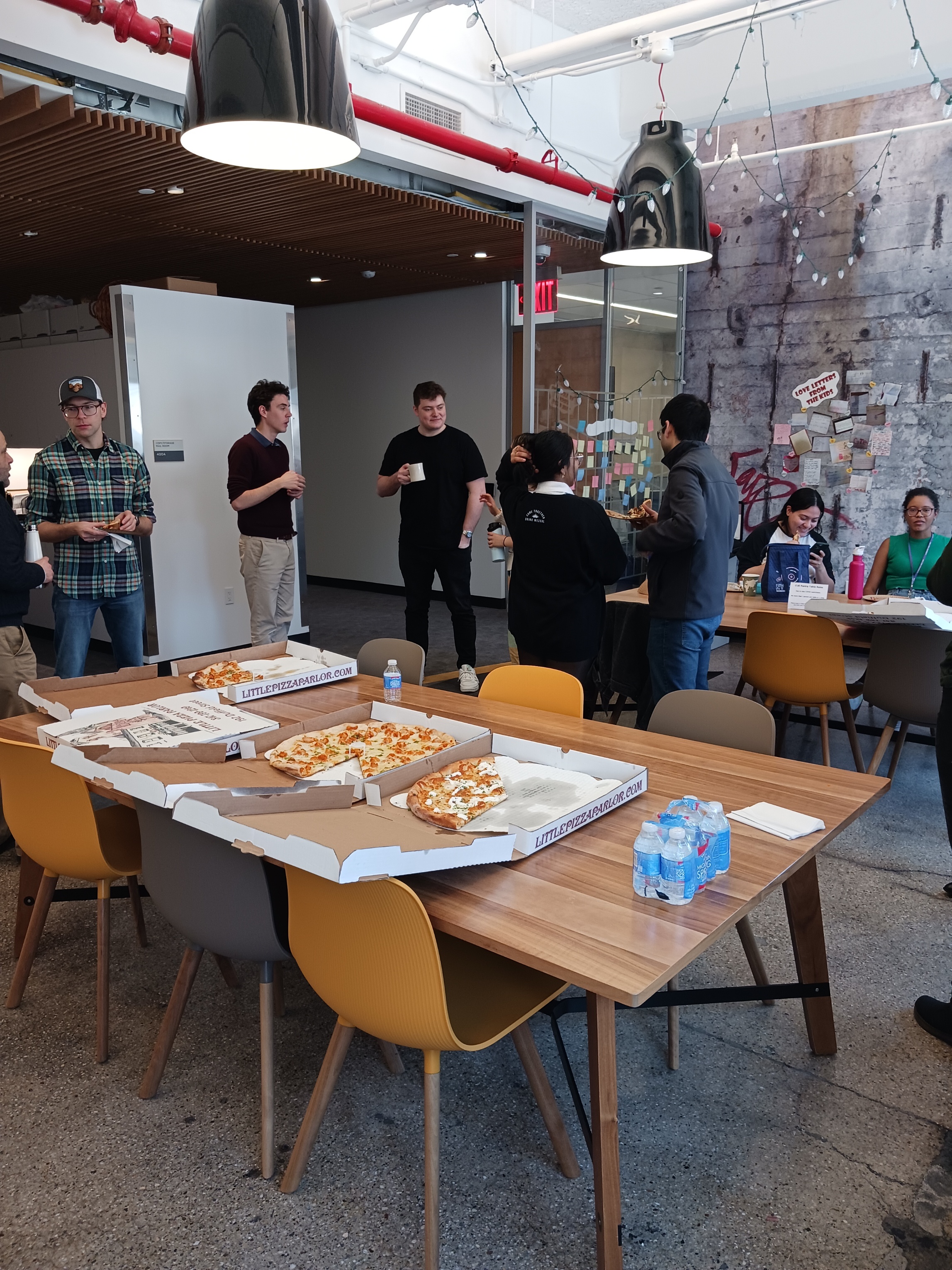 CUE PhD Students talking and having pizzas together