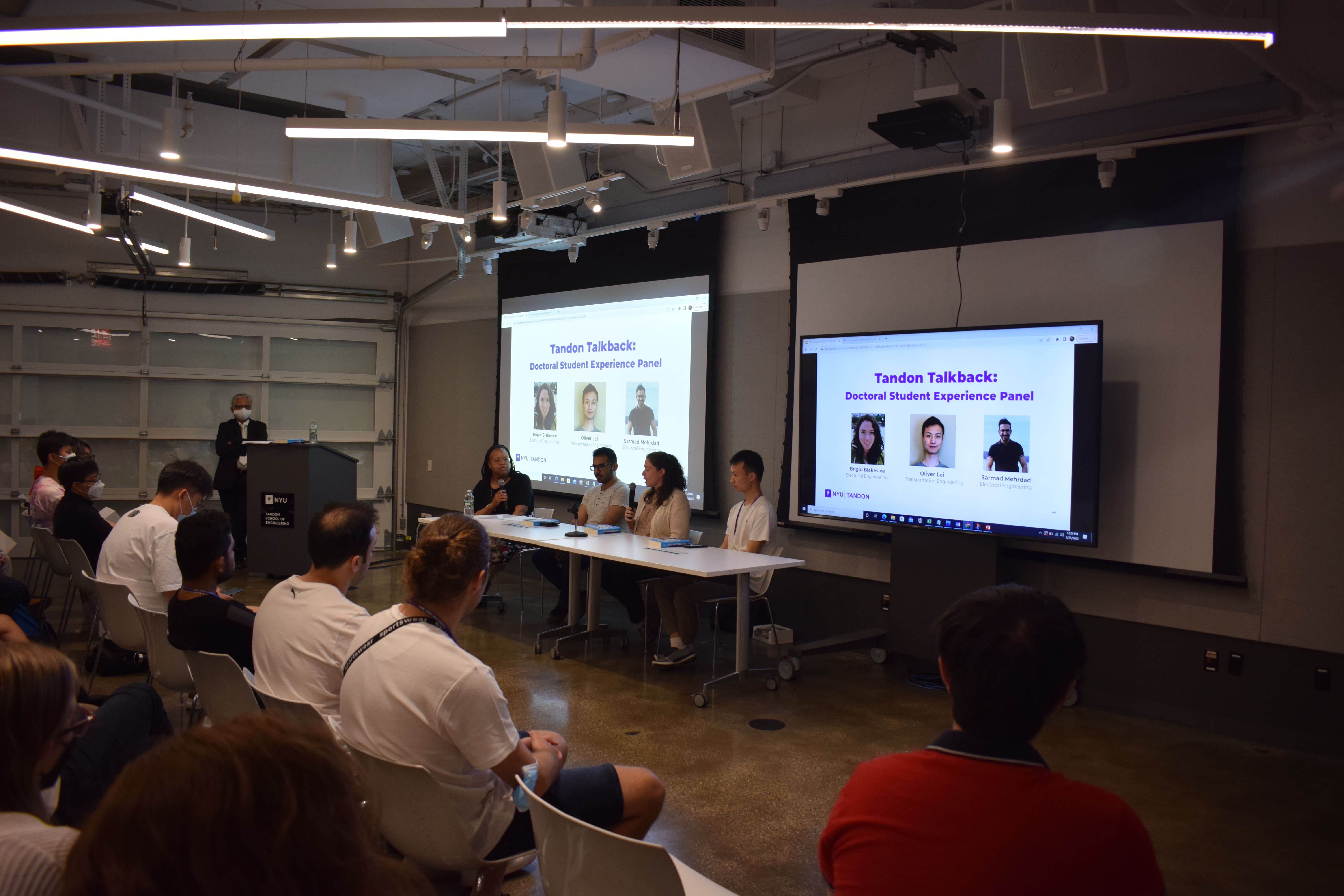 Speakers answering questions in the student orientation